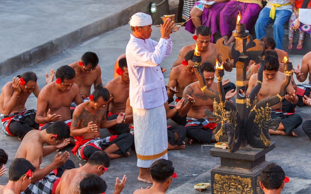Uluwatu Kecak & Fire Dance performers in traditional attire during a ritual in Bali, Indonesia.