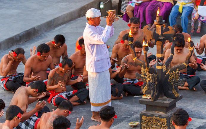 Uluwatu Kecak & Fire Dance performers in traditional attire during a ritual in Bali, Indonesia.