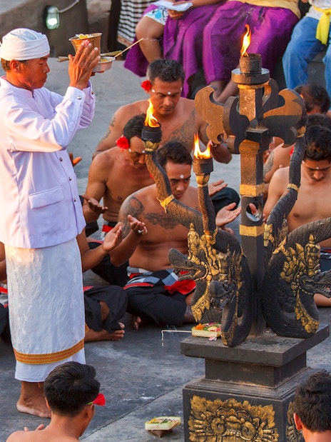Uluwatu Kecak & Fire Dance performers in traditional attire during a ritual in Bali, Indonesia.