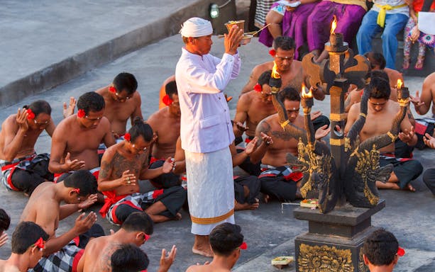 Uluwatu Kecak & Fire Dance performers in traditional attire during a ritual in Bali, Indonesia.