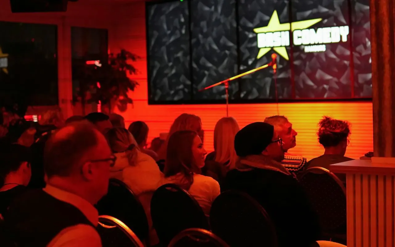 Audience seated at Bash Comedy show in Hamburg St. Pauli with stage and microphone.
