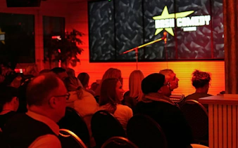 Audience seated at Bash Comedy show in Hamburg St. Pauli with stage and microphone.