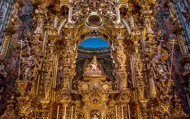 Elaborate gold altar details in El Salvador church, Seville, Andalusia, Spain.