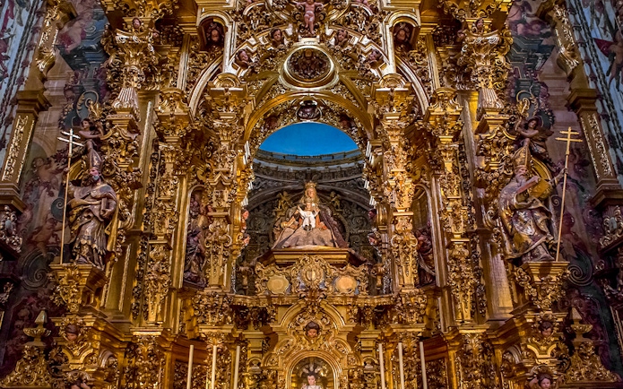Elaborate gold altar details in El Salvador church, Seville, Andalusia, Spain.