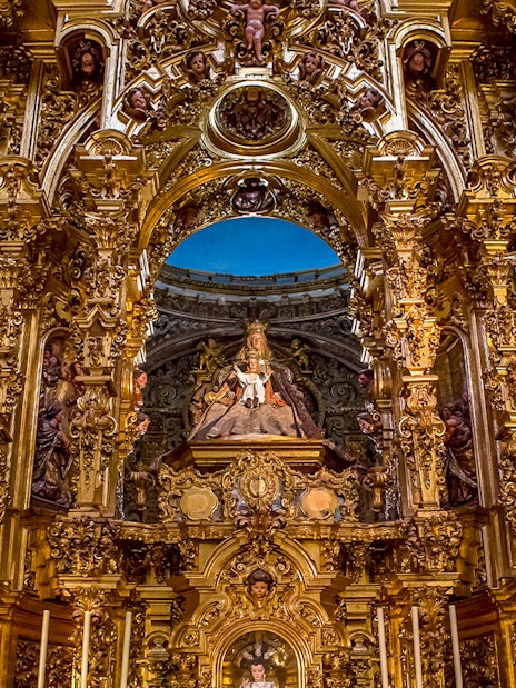 Elaborate gold altar details in El Salvador church, Seville, Andalusia, Spain.
