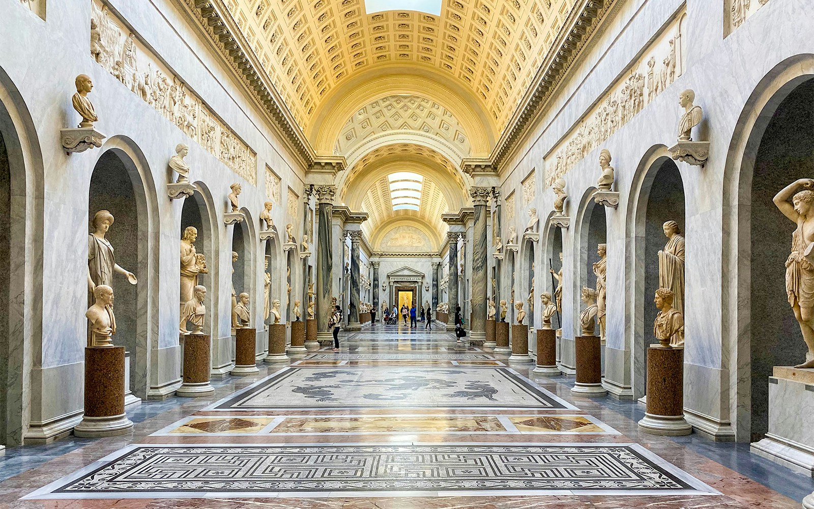 Vatican Museum Collection, Rome - visitors exploring classical sculptures and Renaissance art.