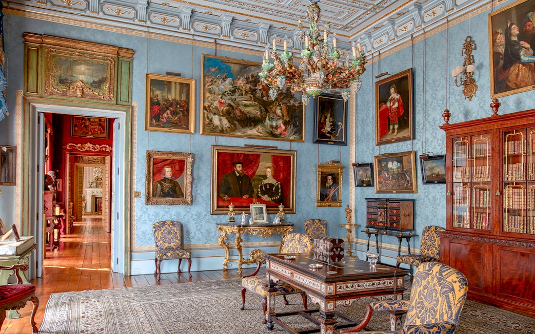 Room with ornate chandelier and paintings in Liria Palace, Madrid.