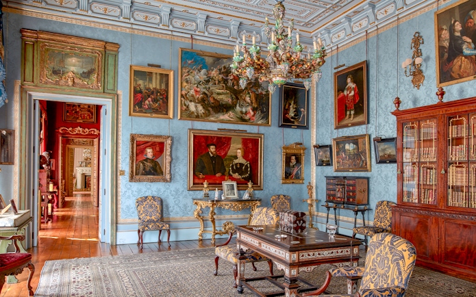 Room with ornate chandelier and paintings in Liria Palace, Madrid.