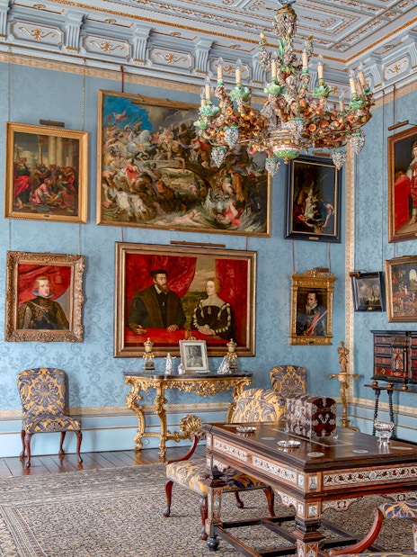 Room with ornate chandelier and paintings in Liria Palace, Madrid.