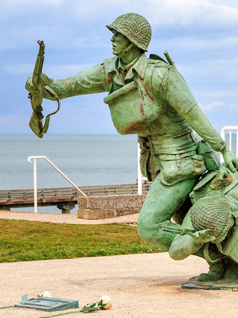 116th Regimental Combat Team Memorial statue in Normandy, France, near the sea.
