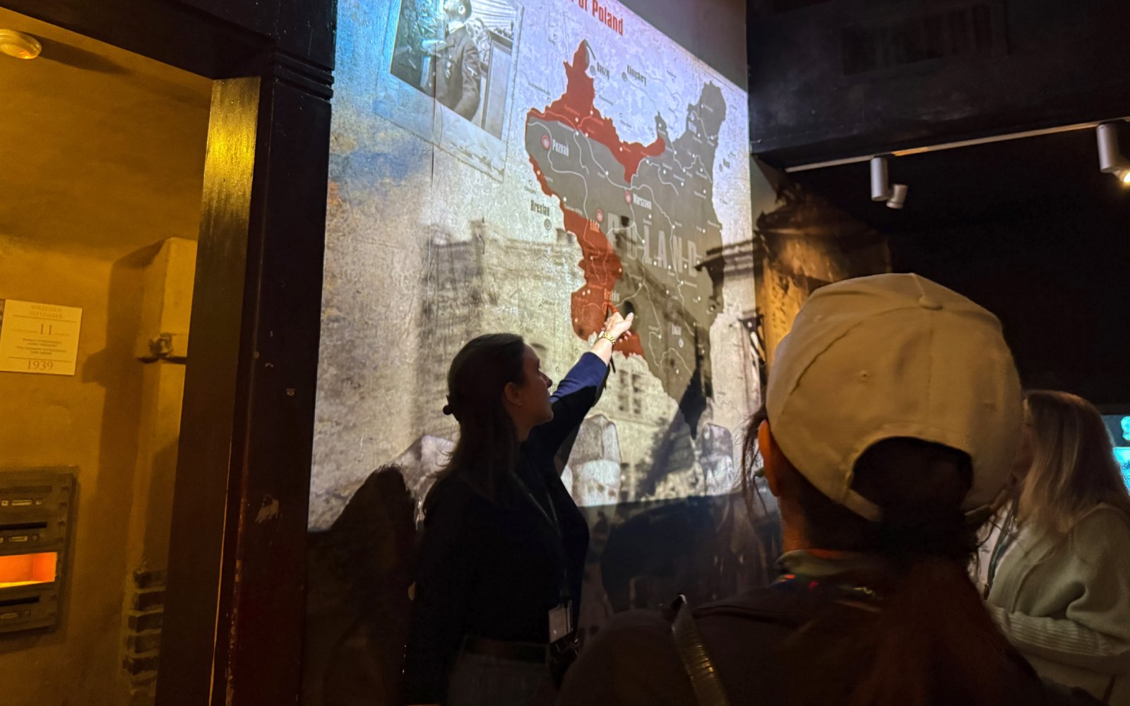 Tour guide explaining map to visitors at Oskar Schindler’s Factory in Krakow.