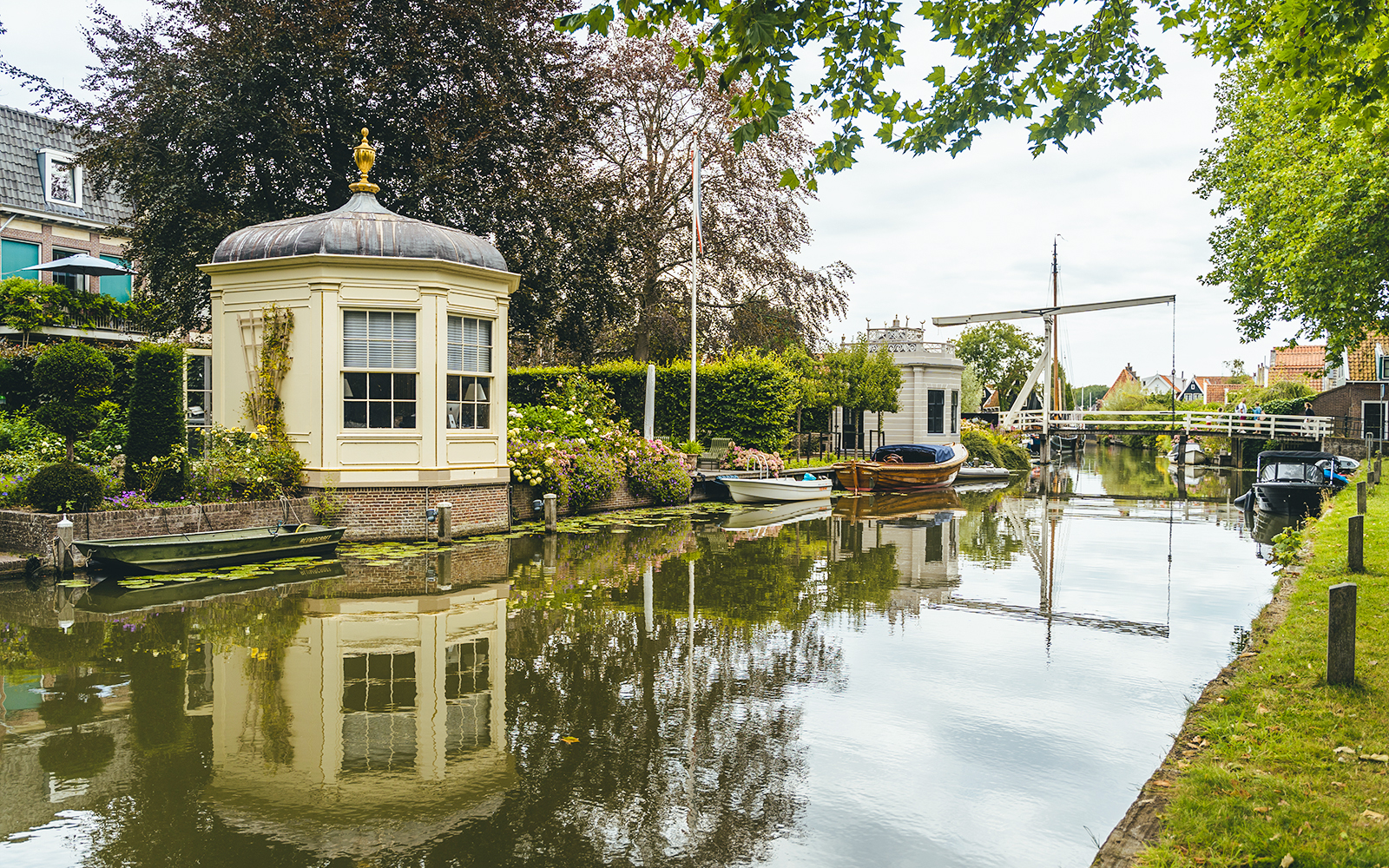 Canal view with historic buildings and boats in Edam, Netherlands.