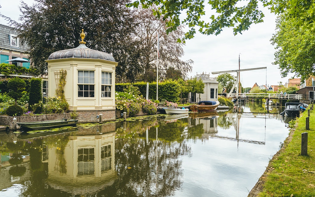 Canal view with historic buildings and boats in Edam, Netherlands.