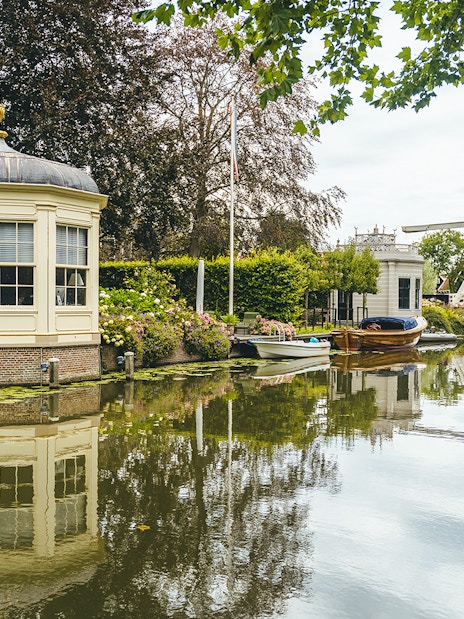 Canal view with historic buildings and boats in Edam, Netherlands.