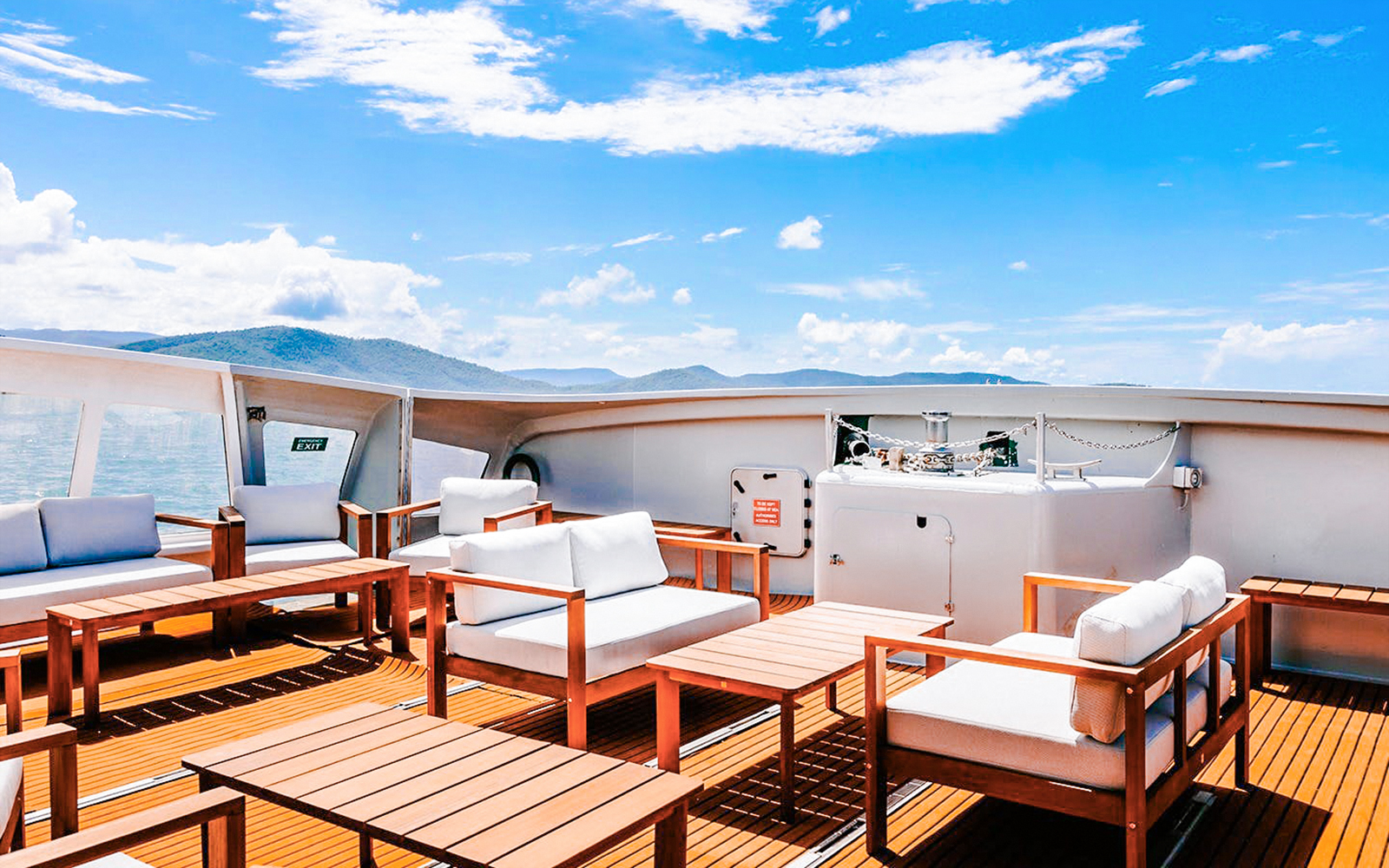 Outdoor seating area on a boat deck during ZigZag Whitsundays Day Tour.