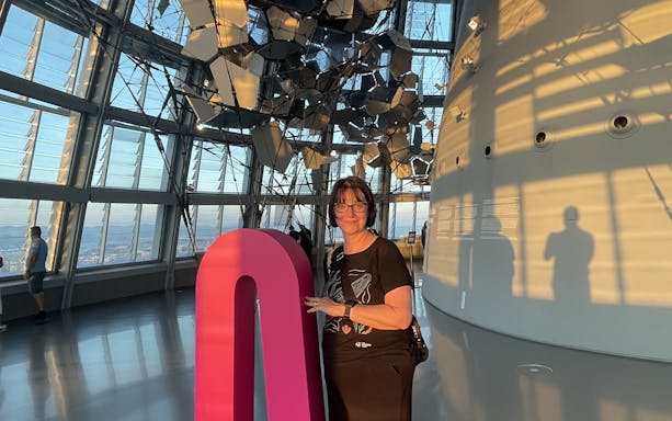Tourist inside Glories Skyline Tower with modern architecture and city view.