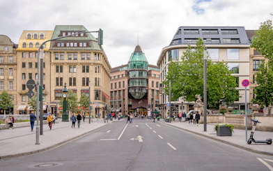 Konigsallee street view in Dusseldorf with historic buildings and pedestrians.
