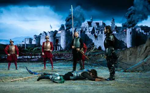 Medieval reenactment with soldiers and castle backdrop, Willem van Oranje theme.