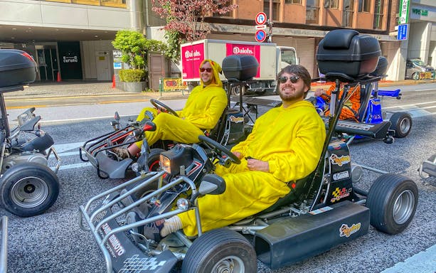 Go-kart riders in yellow costumes on a Tokyo street during the Shibuya-Tokyo Tower-Roppongi hills tour.