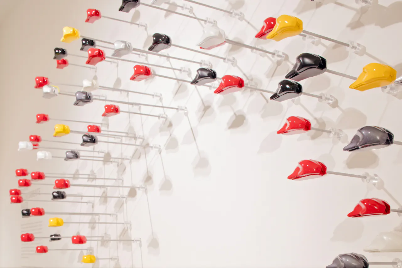 Colorful motorcycle helmets display at Ducati Museum, Bologna.