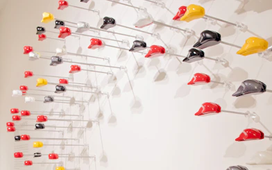 Colorful motorcycle helmets display at Ducati Museum, Bologna.