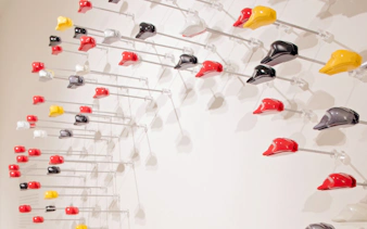 Colorful motorcycle helmets display at Ducati Museum, Bologna.