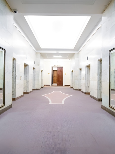 Elevator lobby inside Palace of Culture and Science, Warsaw, with mirrored walls.