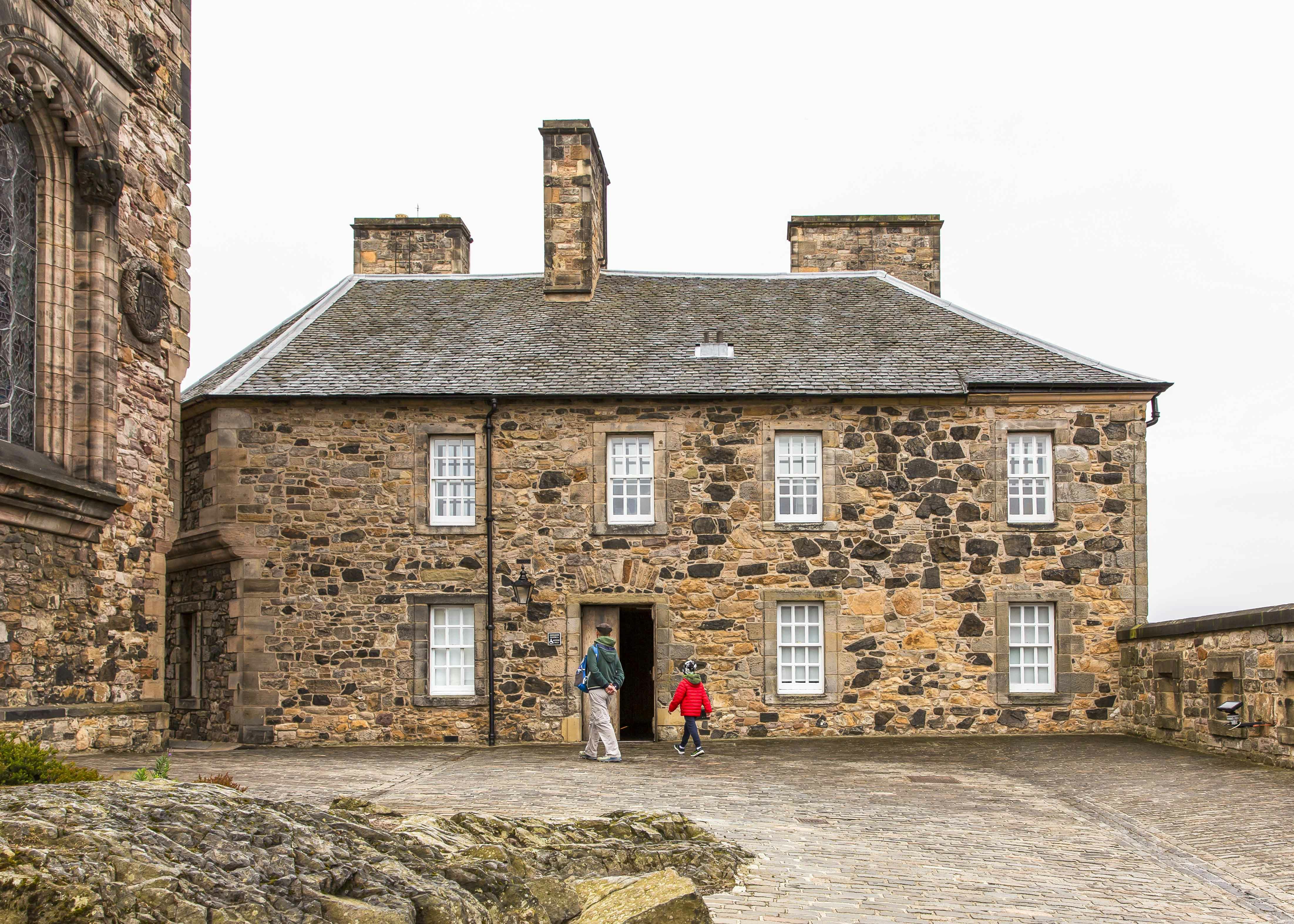 Visitors entering the historic Queen Anne Building at Edinburgh Castle.