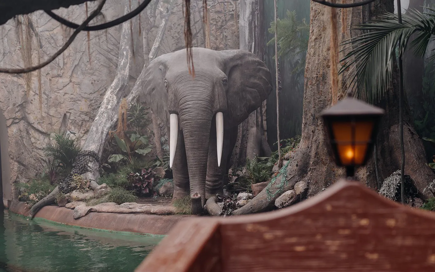 Elephant statue in jungle setting at World of Discoveries Interactive Digital Exhibition.