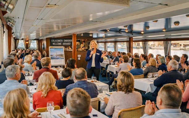 Guide speaking to guests on Fika Ship in Stockholm.