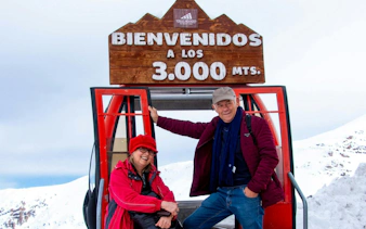 Tourists at Valle Nevado ski resort entrance in the Andes Mountains, Chile.