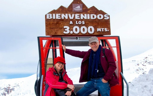 Tourists at Valle Nevado ski resort entrance in the Andes Mountains, Chile.