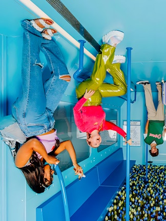 Visitors enjoying an upside-down room at The Upside Down Amsterdam exhibit.