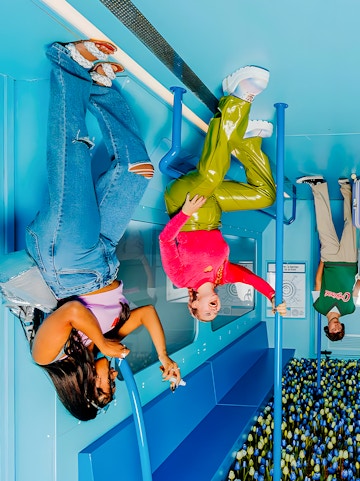 Visitors enjoying an upside-down room at The Upside Down Amsterdam exhibit.