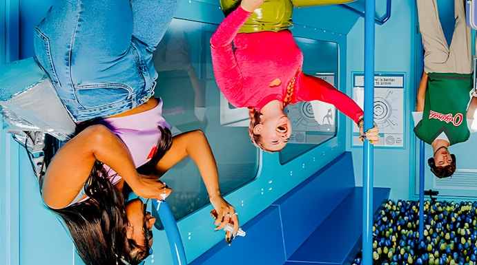 Visitors enjoying an upside-down room at The Upside Down Amsterdam exhibit.