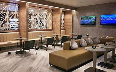 Mera VIP Lounge seating area with modern decor at Cancun International Airport.