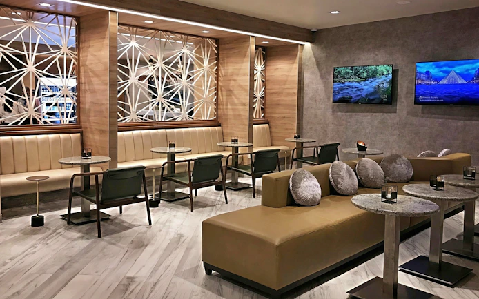 Mera VIP Lounge seating area with modern decor at Cancun International Airport.