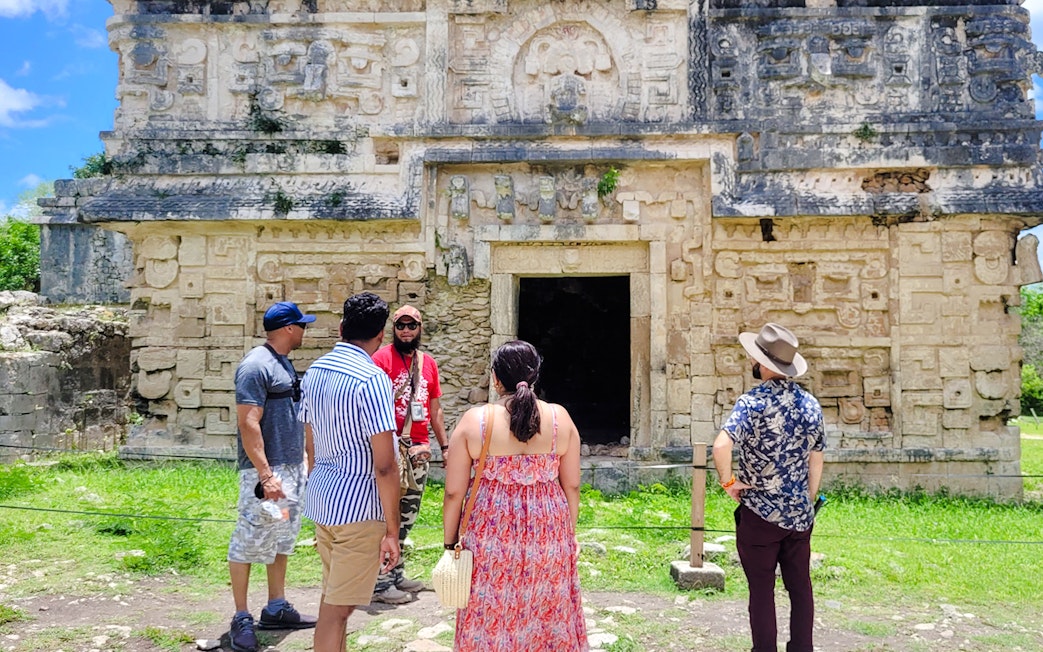 Tourists exploring ancient Mayan ruins at Chichen Itza, Mexico.