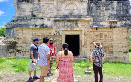 Tourists exploring ancient Mayan ruins at Chichen Itza, Mexico.