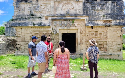 Tourists exploring ancient Mayan ruins at Chichen Itza, Mexico.