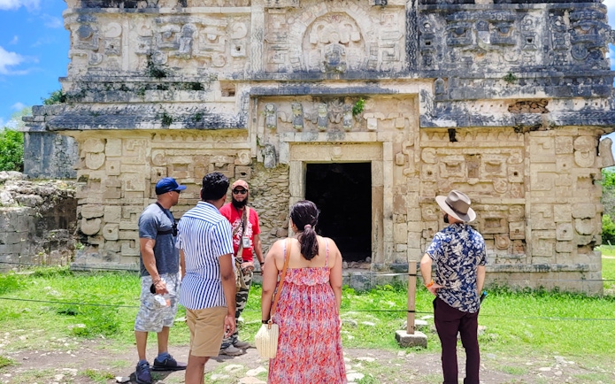 Tourists exploring ancient Mayan ruins at Chichen Itza, Mexico.