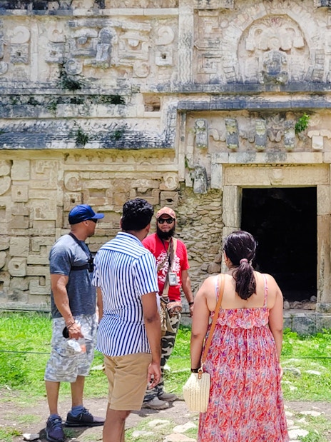 Tourists exploring ancient Mayan ruins at Chichen Itza, Mexico.