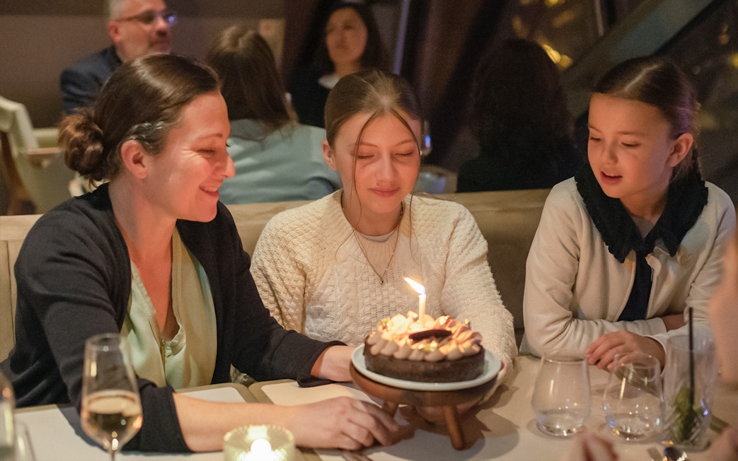 Guests enjoying a birthday celebration at Madame Brasserie, Eiffel Tower.