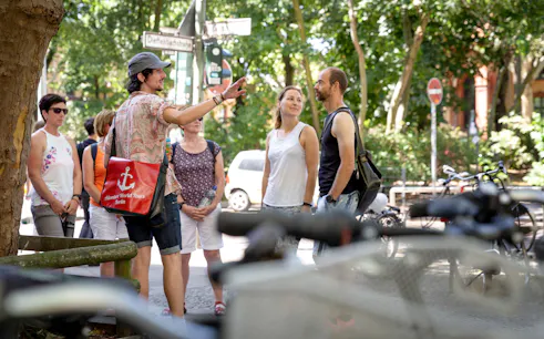 Tour guide leading a group on a Kreuzberg food tour in Berlin.