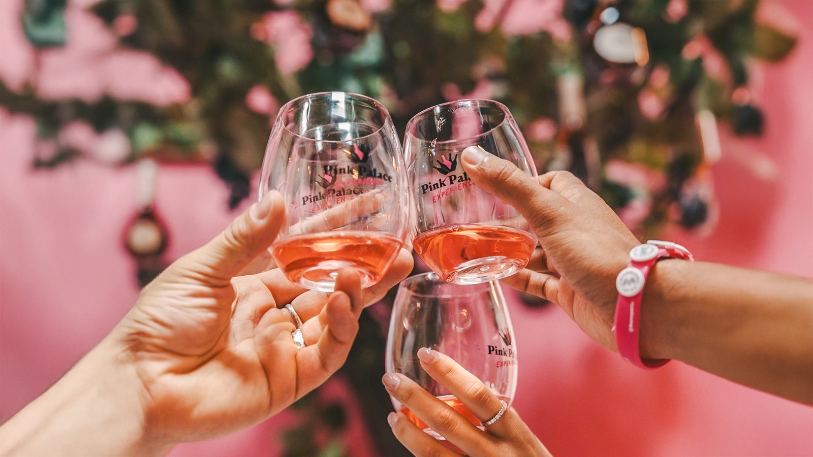 Guests toasting with rosé wine at Pink Palace experience.