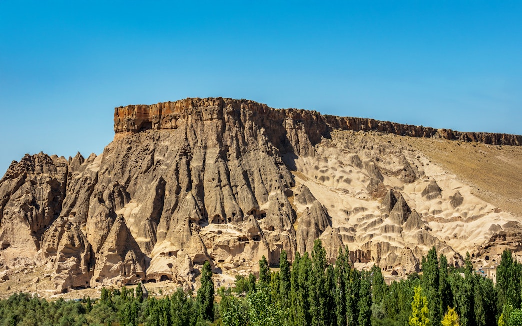 Panoramic view of Ihlara Valley's rock formations and greenery, Cappadocia, Turkey.