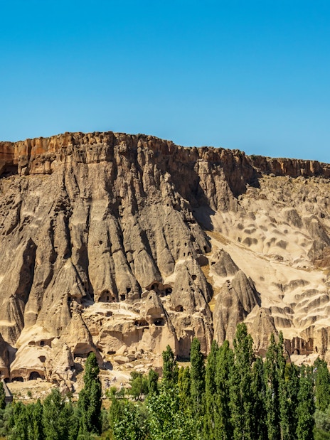 Panoramic view of Ihlara Valley's rock formations and greenery, Cappadocia, Turkey.