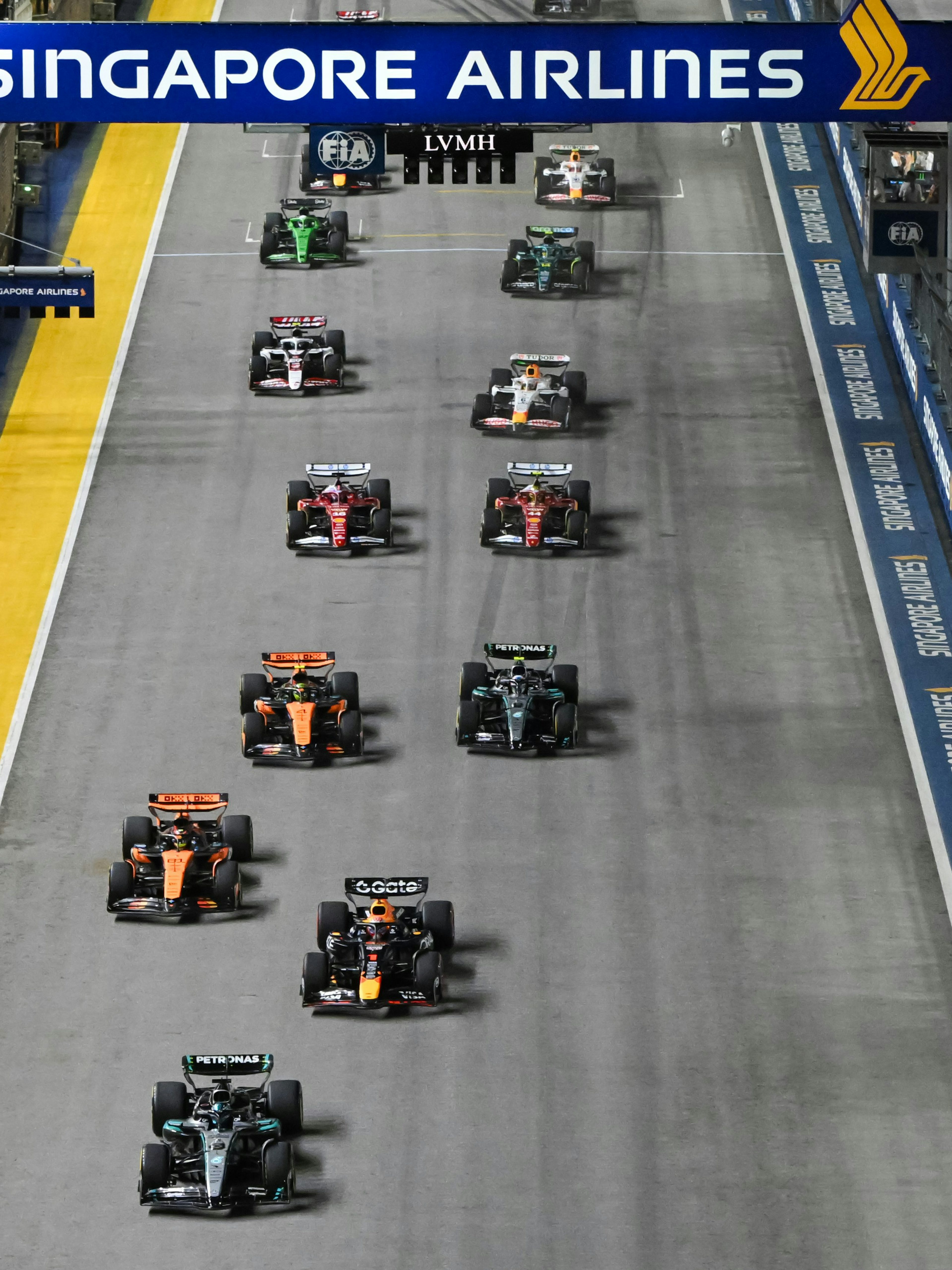 Cars racing down the Pit Straight at Singapore Grand Prix.