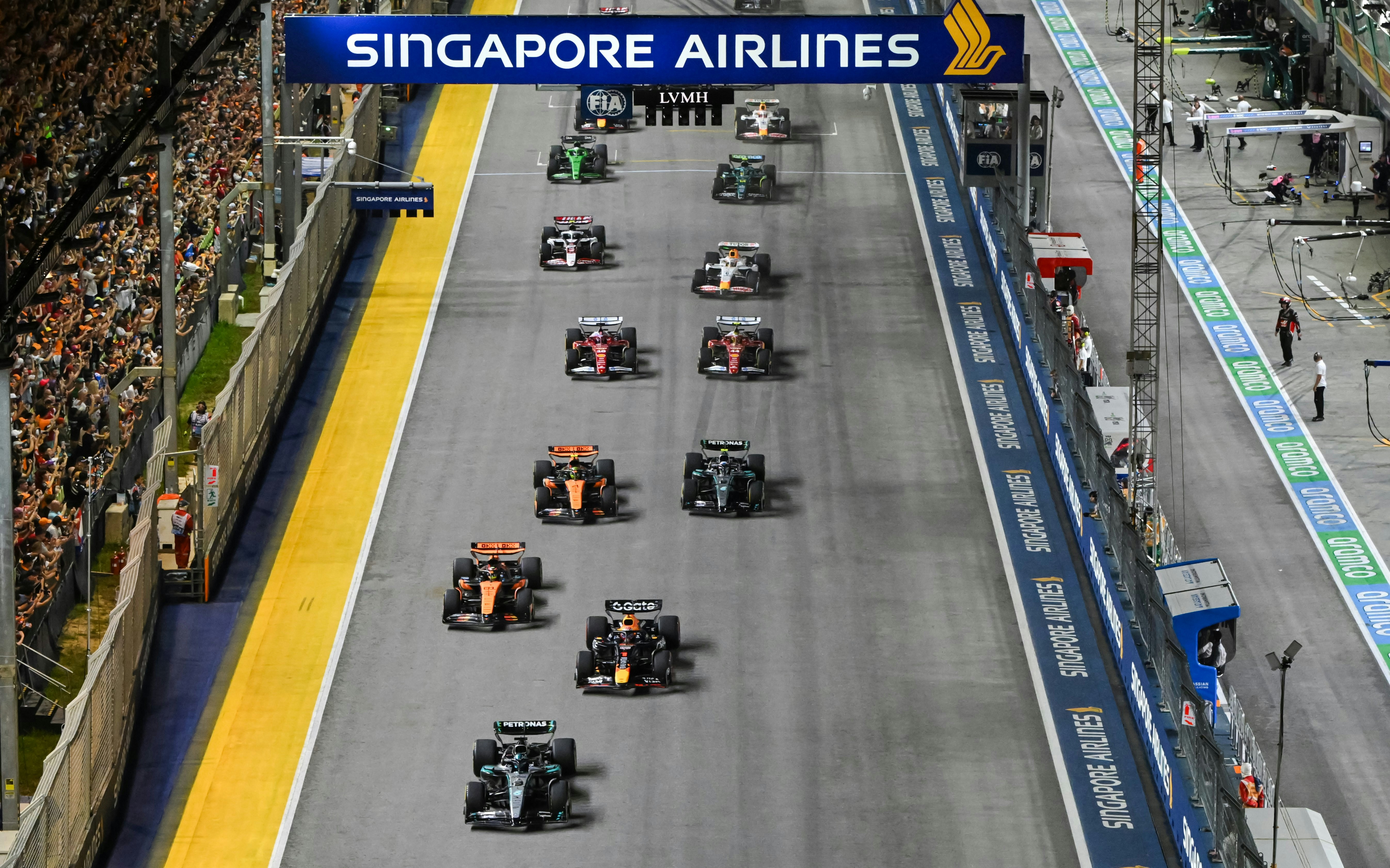 Cars racing down the Pit Straight at Singapore Grand Prix.