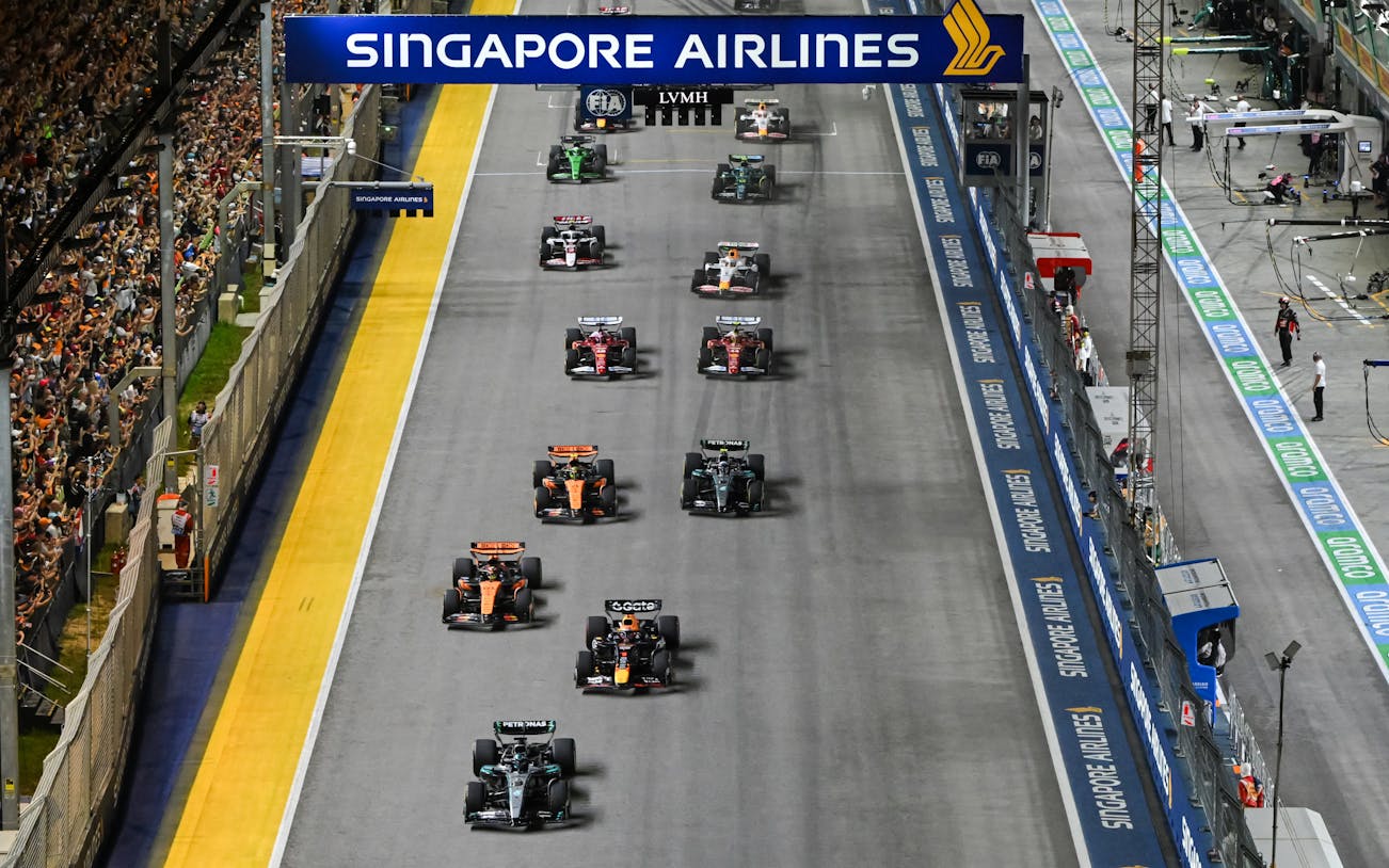 Cars racing down the Pit Straight at Singapore Grand Prix.